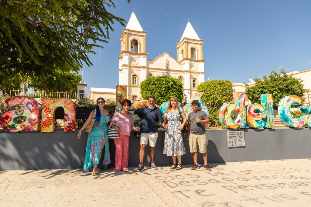 An Eating With Carmen Food Tours group in front of the mission in downtown San José del Cabo